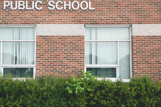 A public school building representing the budget and funding planning process for reading technology